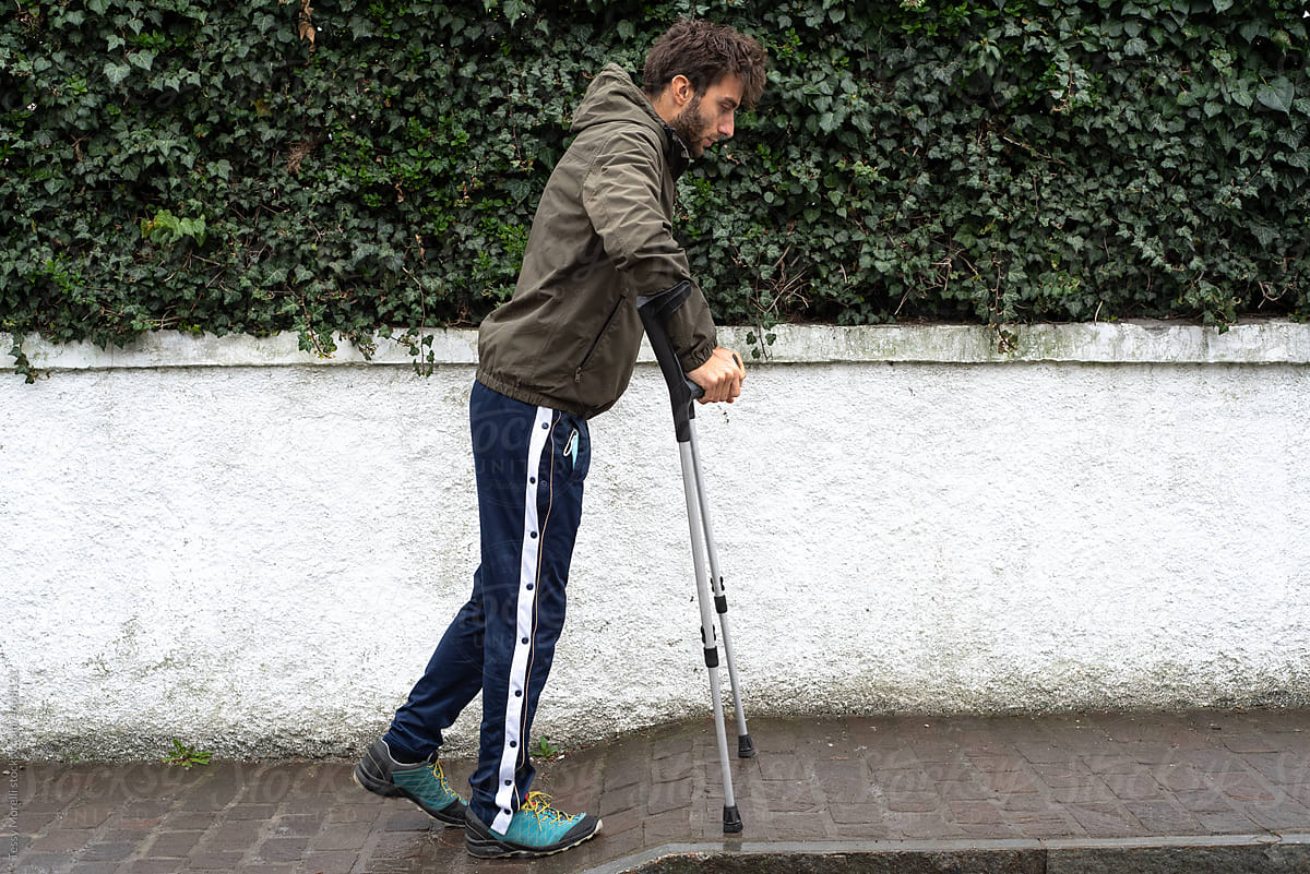 Carefully taking the first walk steps with crutches after injury