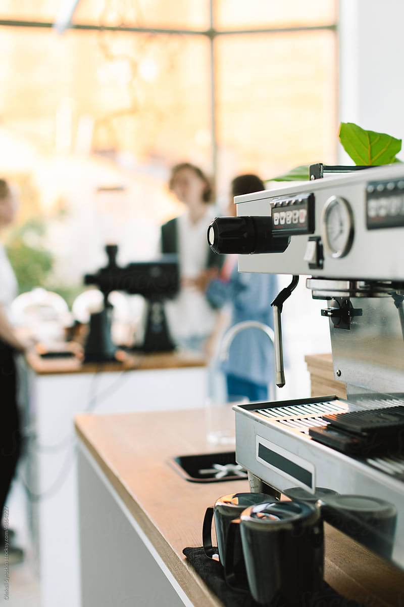 Coffee Maker Standing in Quiet Cafe with Greenery