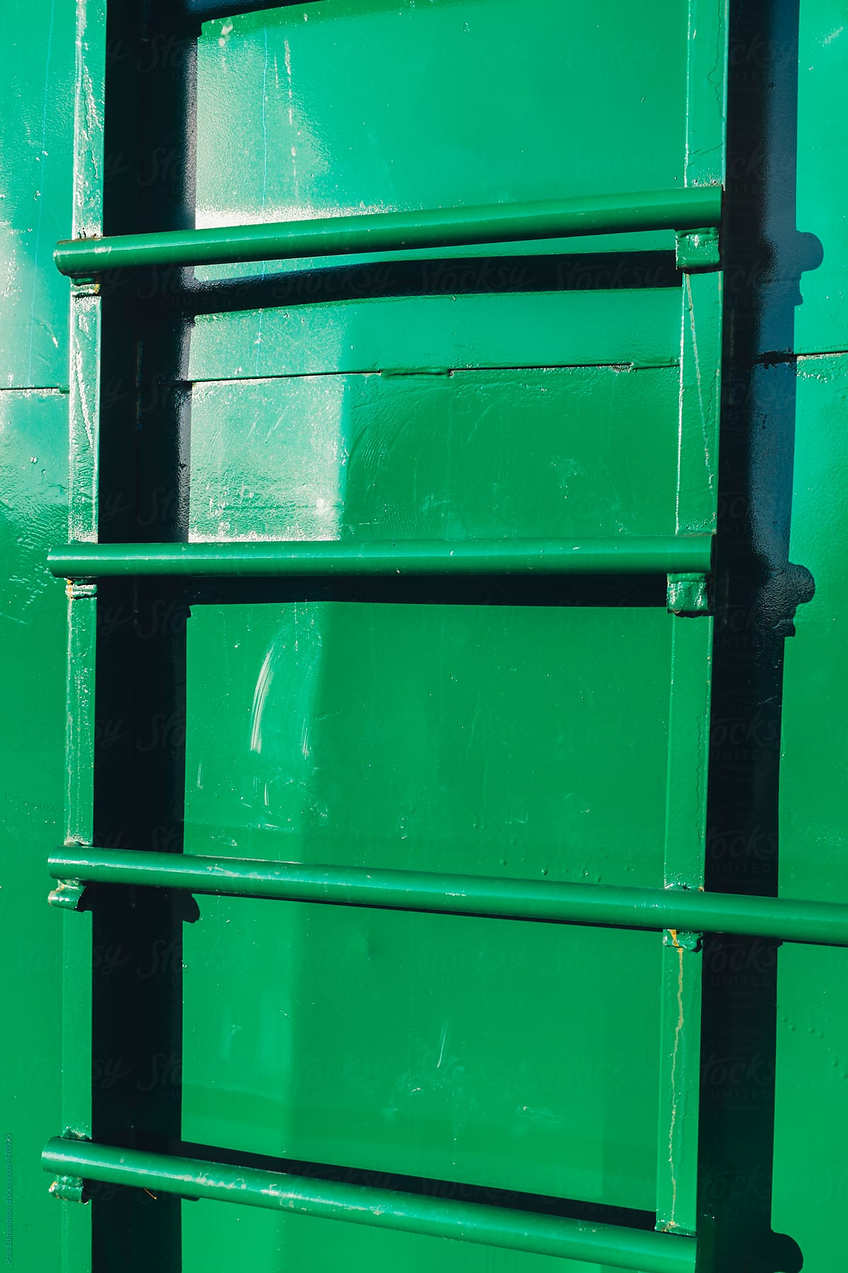Ladder on green metal container, close up
