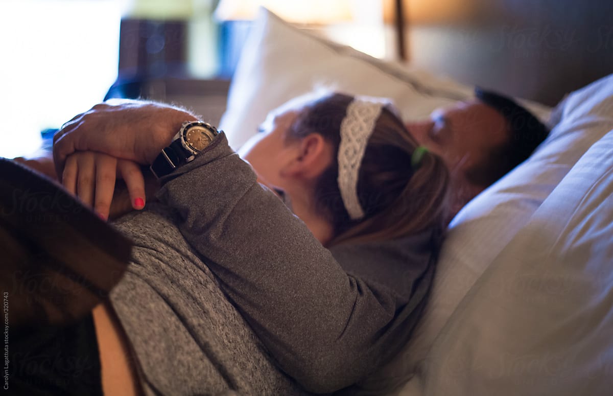 Father And Daughter Embracing While Watching Tv By Stocksy