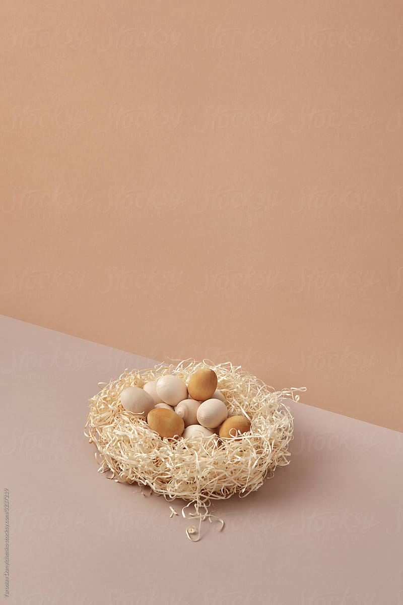 Handmade wood Easter eggs in shavings nest.