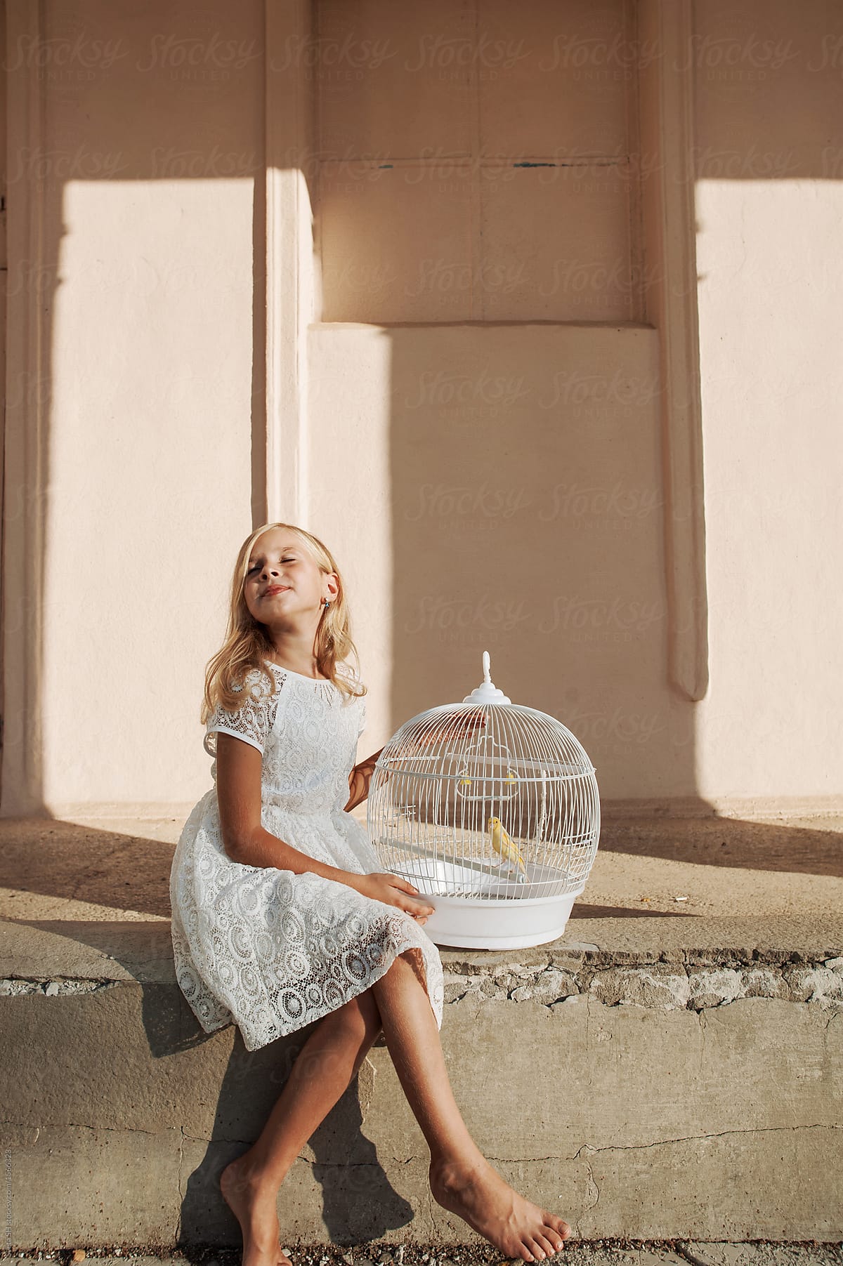 Girl with a cage for birds