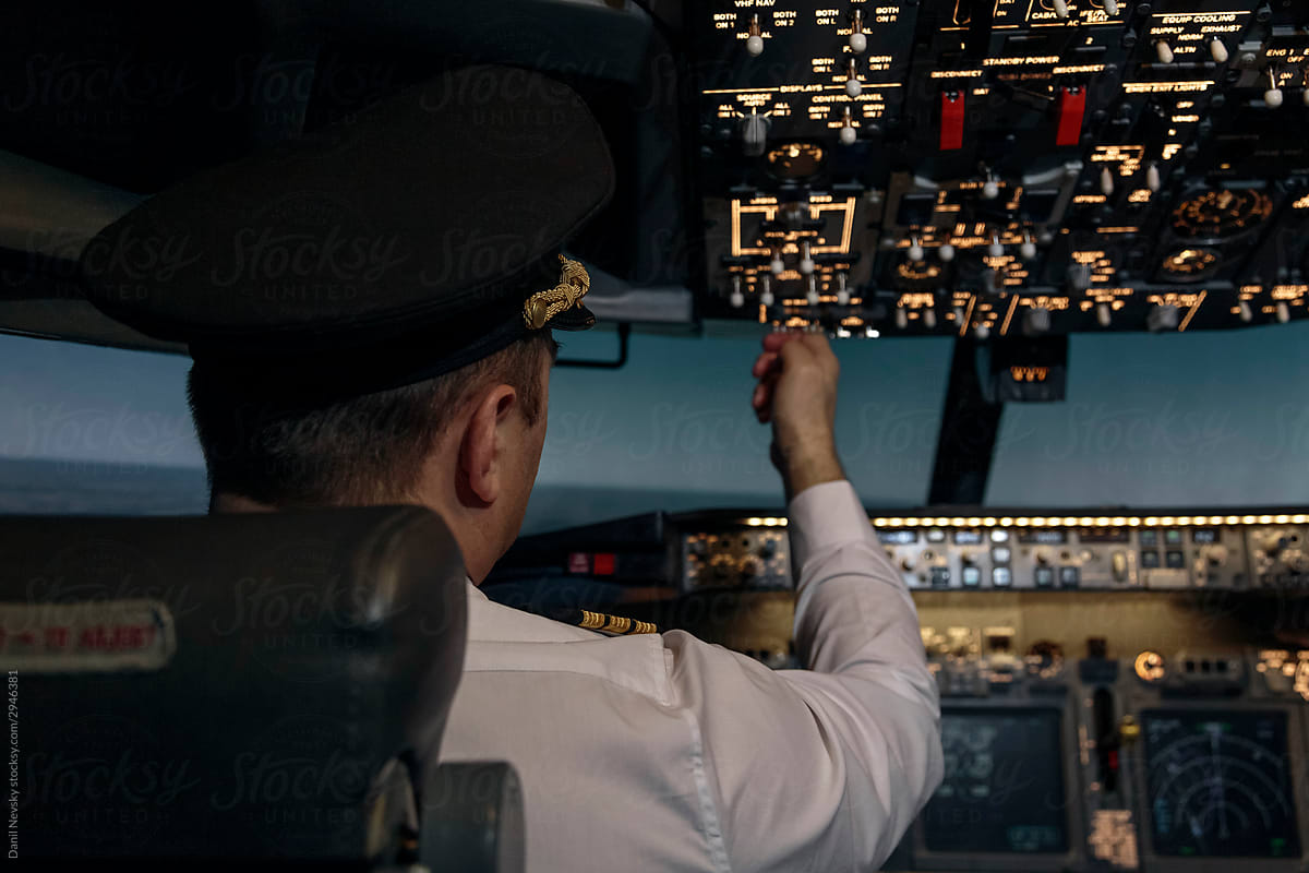 Pilot in flight deck of airplane