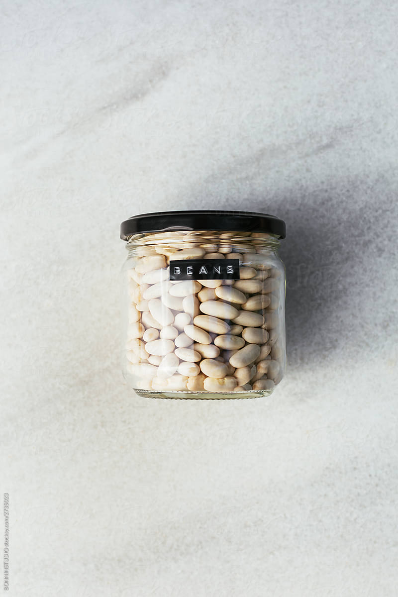 Jar of raw beans on table