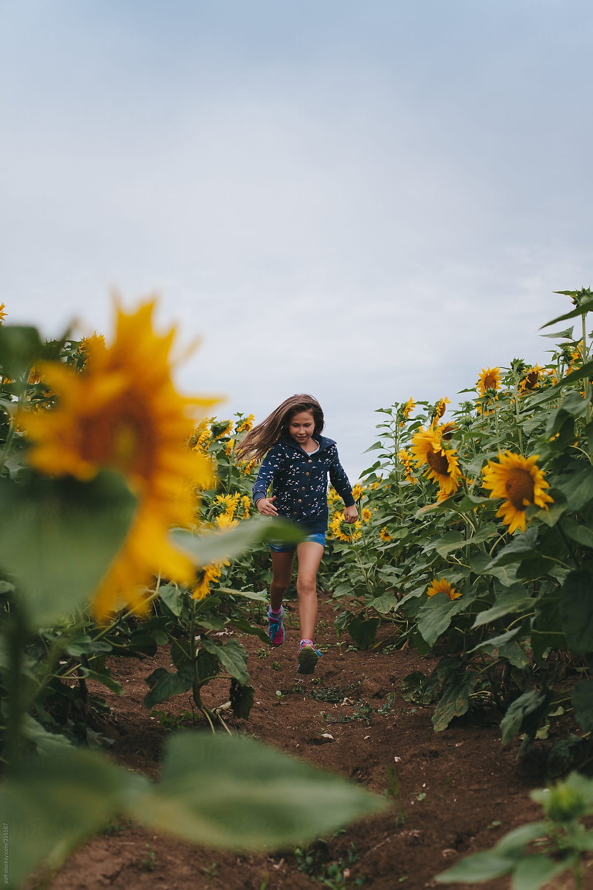 little girl running in field