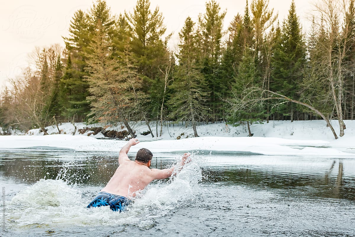 Man Diving and Swimming In Ice Cold Frozen Winter River Polar Bear Dip