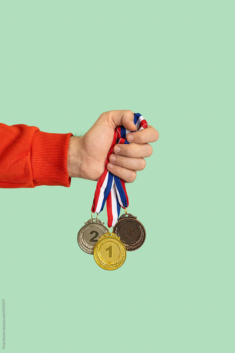 Person holding medals. Success, competition, winner, award.