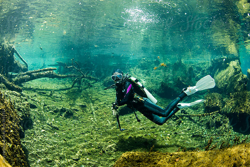 A scuba diver swimming in Mexico\'s  Cenote Kukulcan