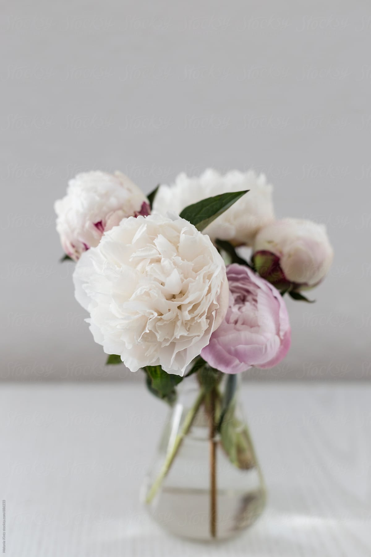 Small bouquet of peonies on top of a shelf