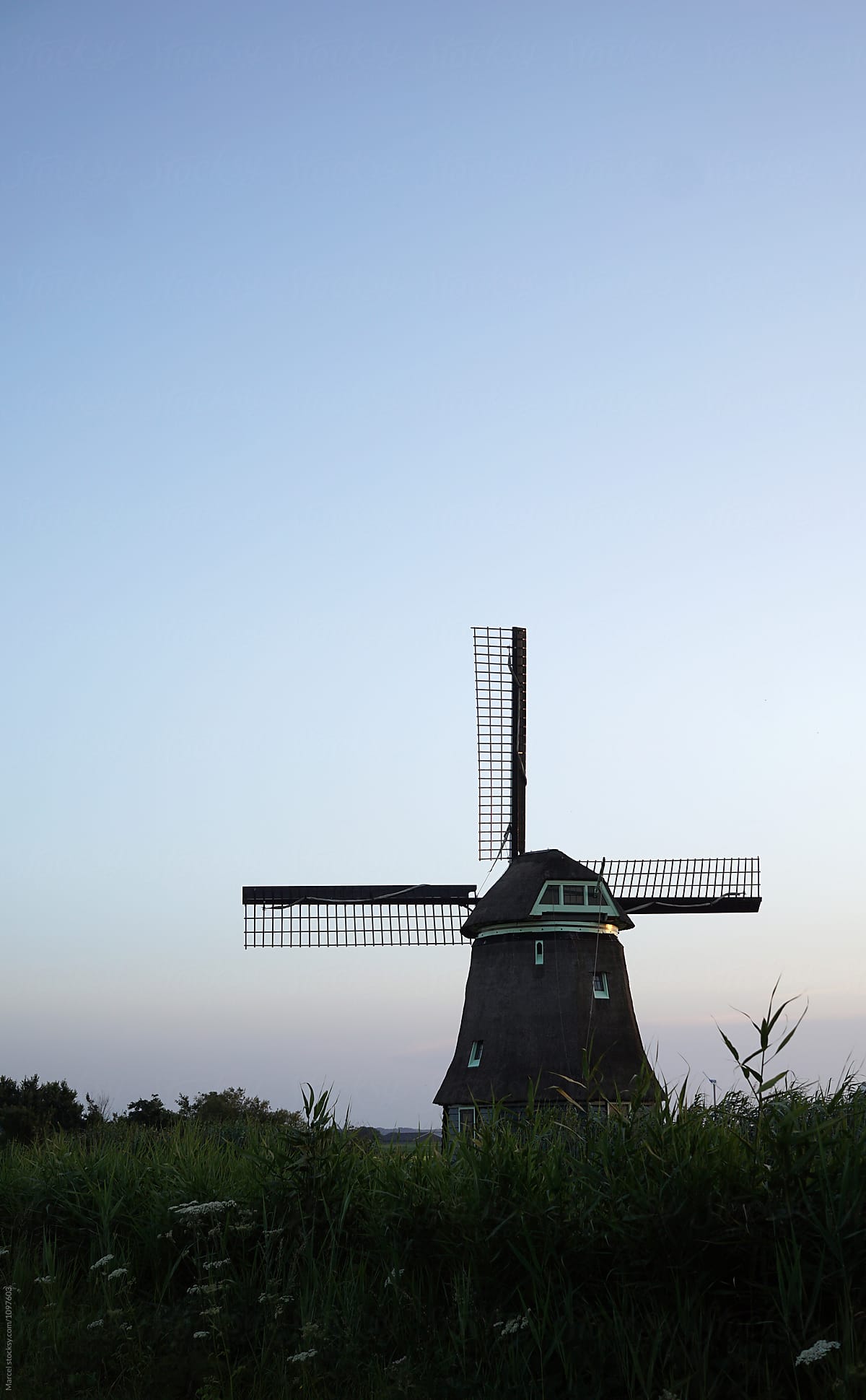 Old Dutch windmill at sunset