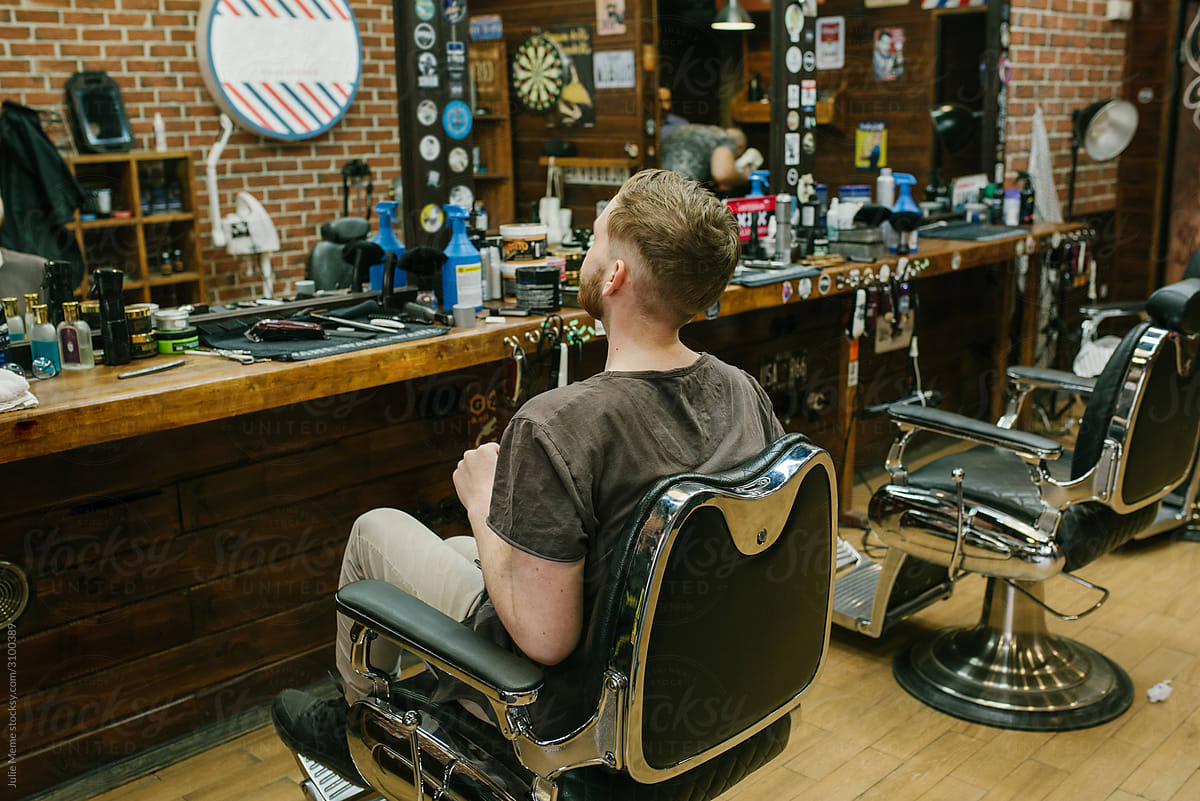A client sits on the chair in the barbershop