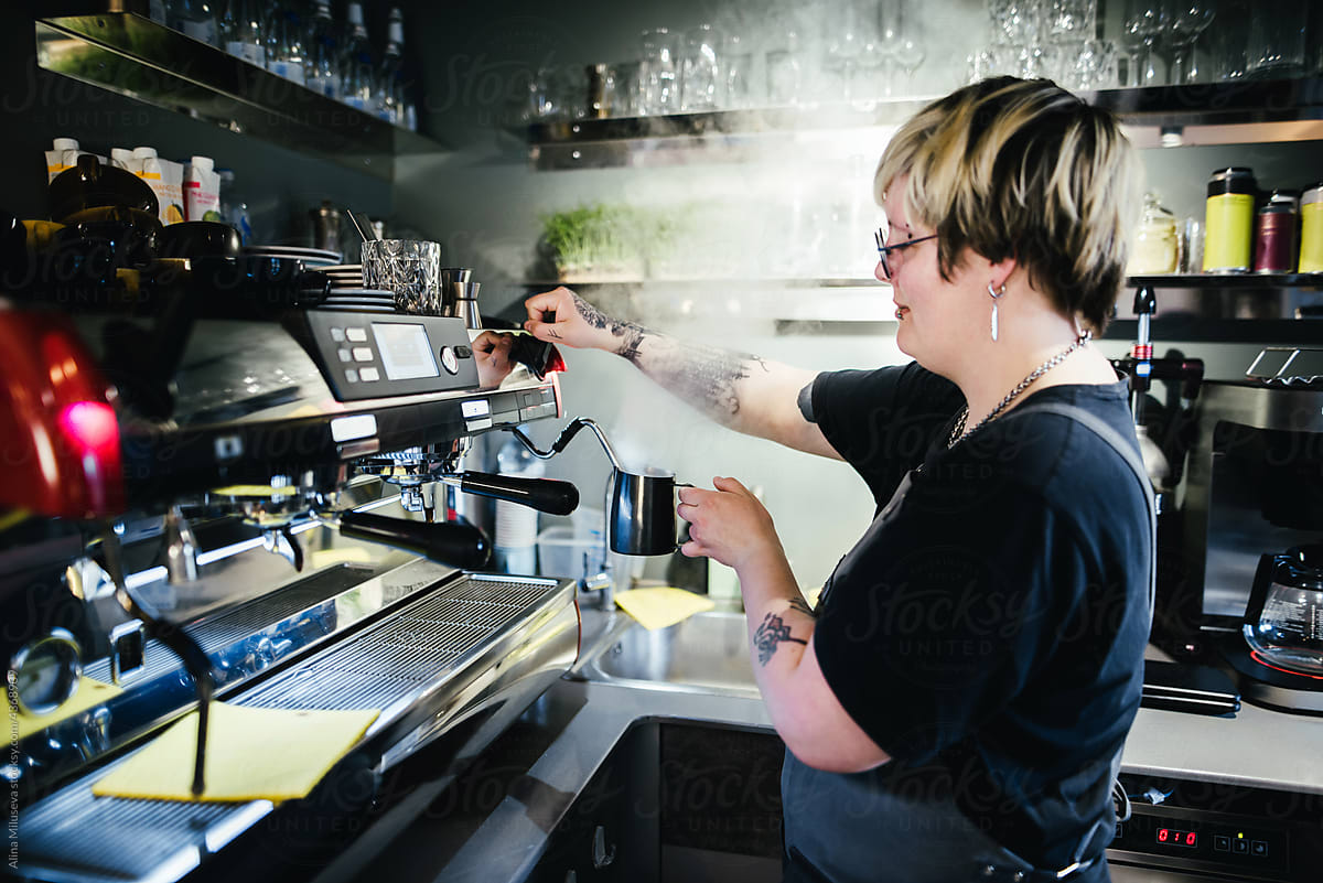 Hipster woman preparing coffee with machine