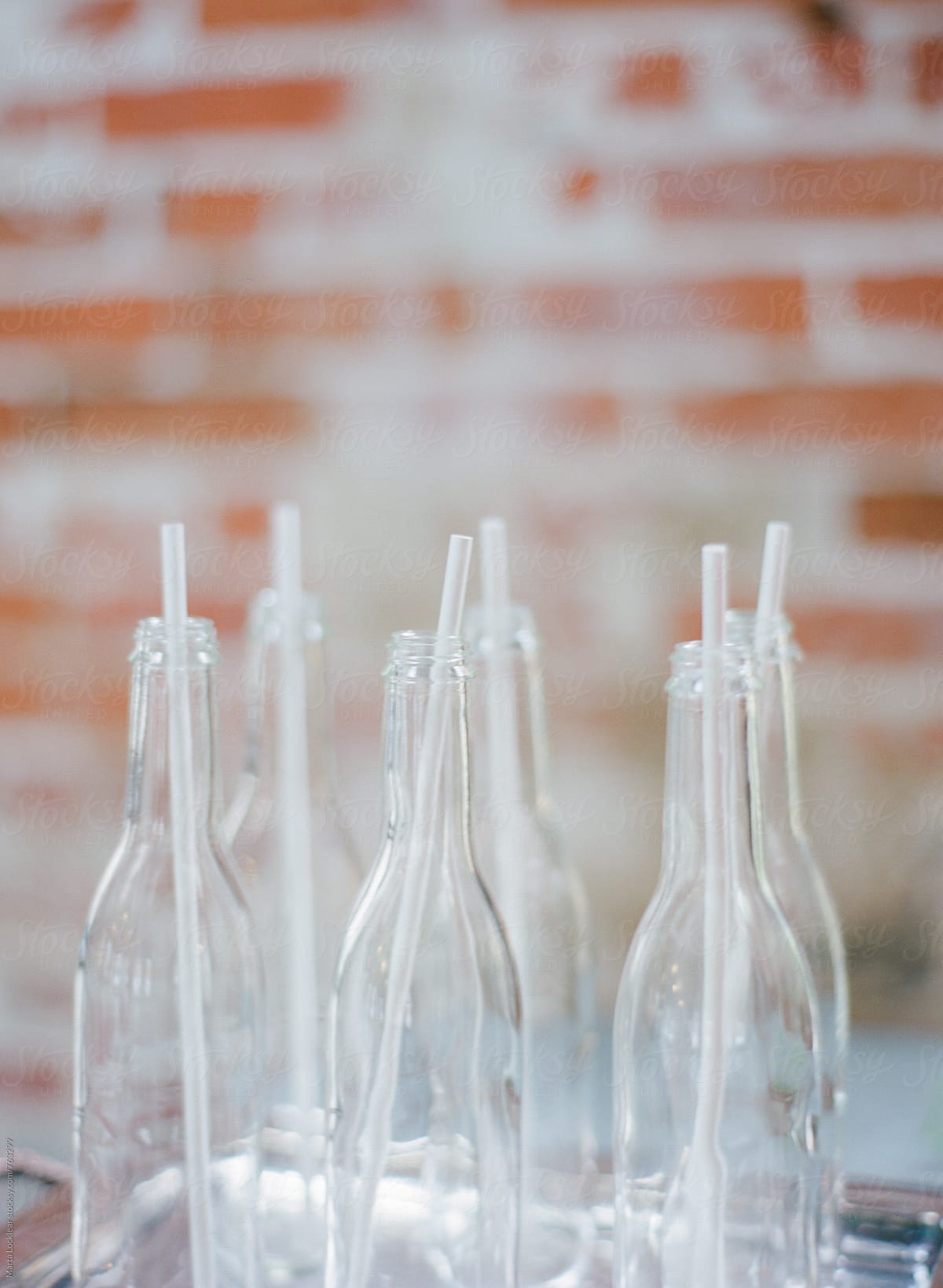 Empty glass bottles with straws