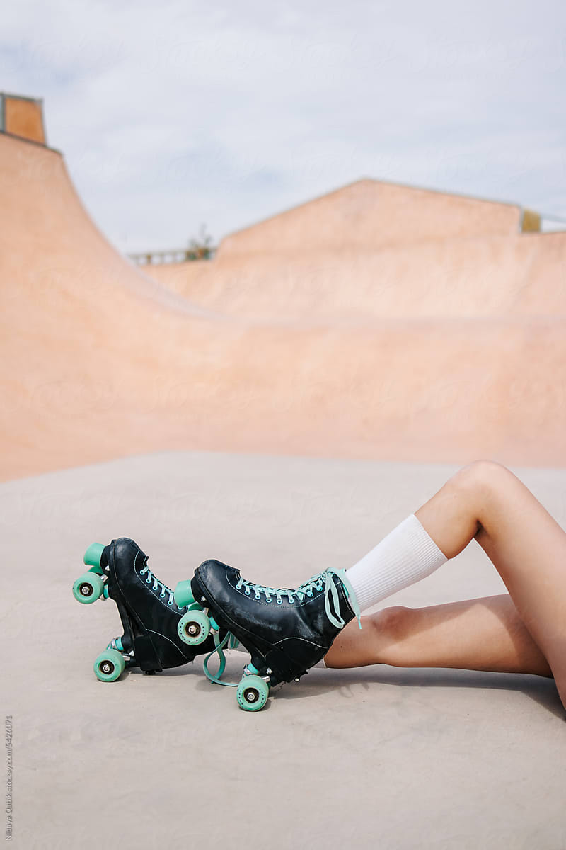 Detail of roller skates and the fit legs of a young skater girl