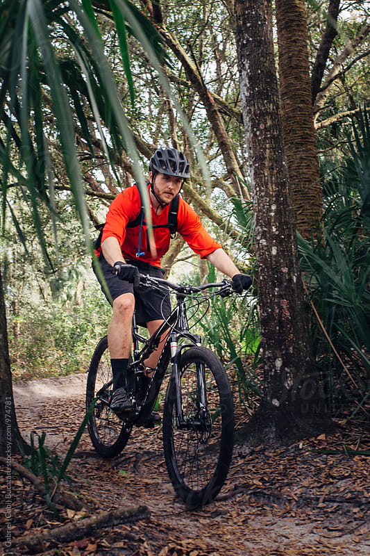Mountain Bike rider through a tropical forest trail
