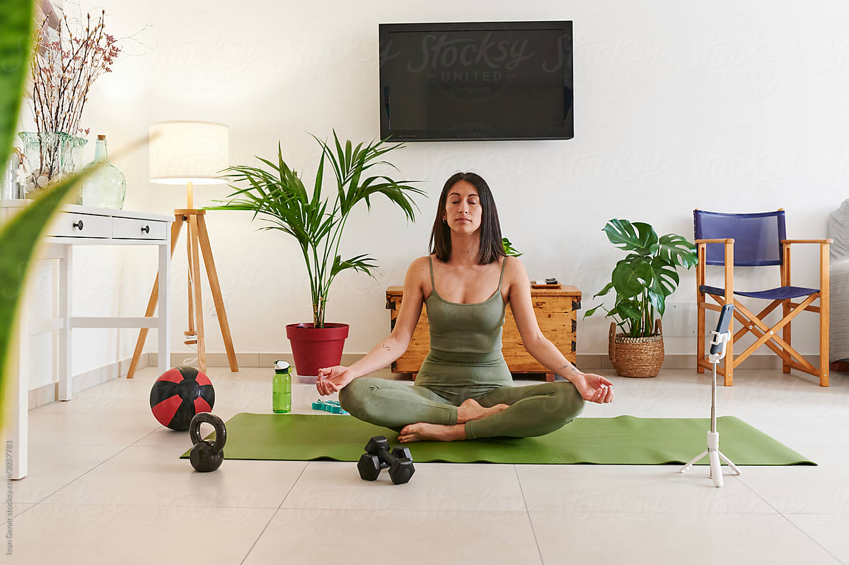 Fit woman vlogging her yoga meditation
