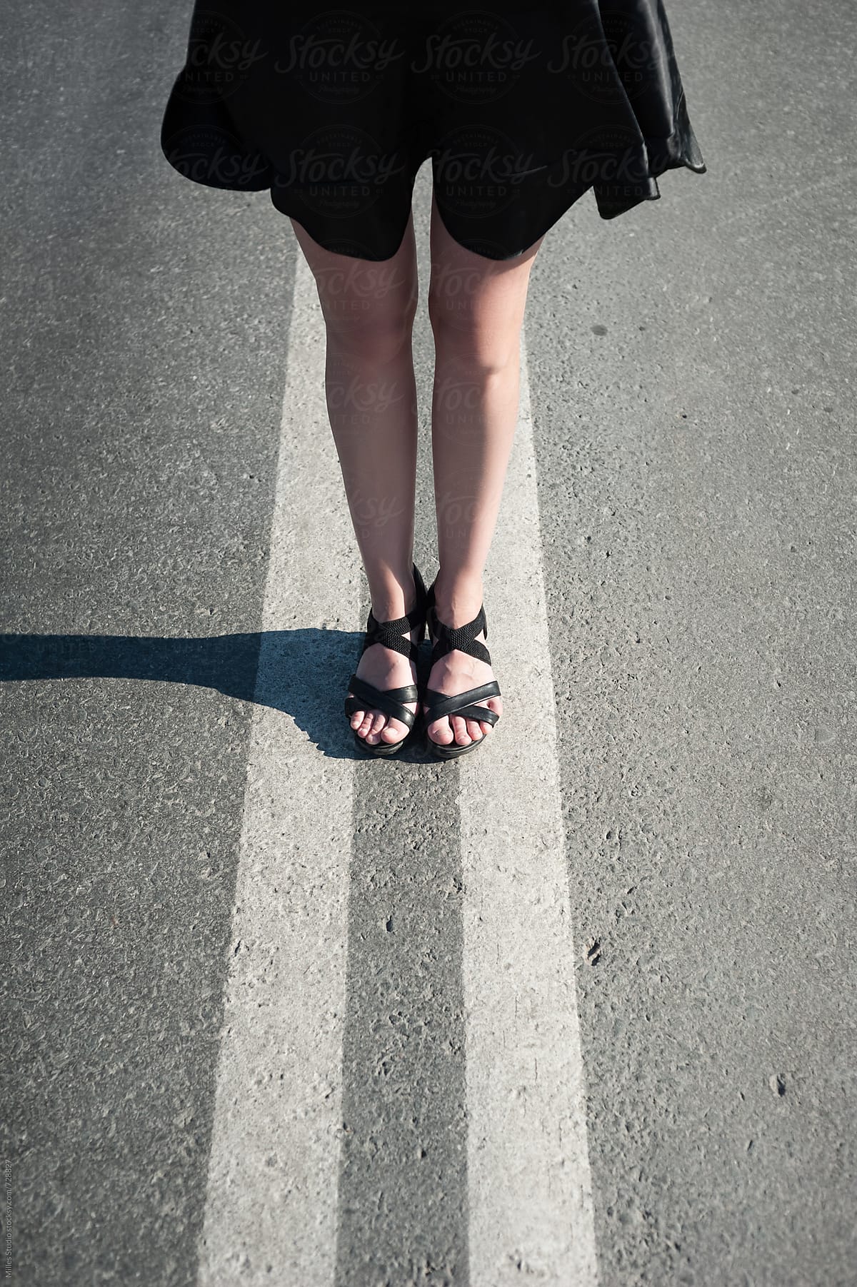 Female legs on a road