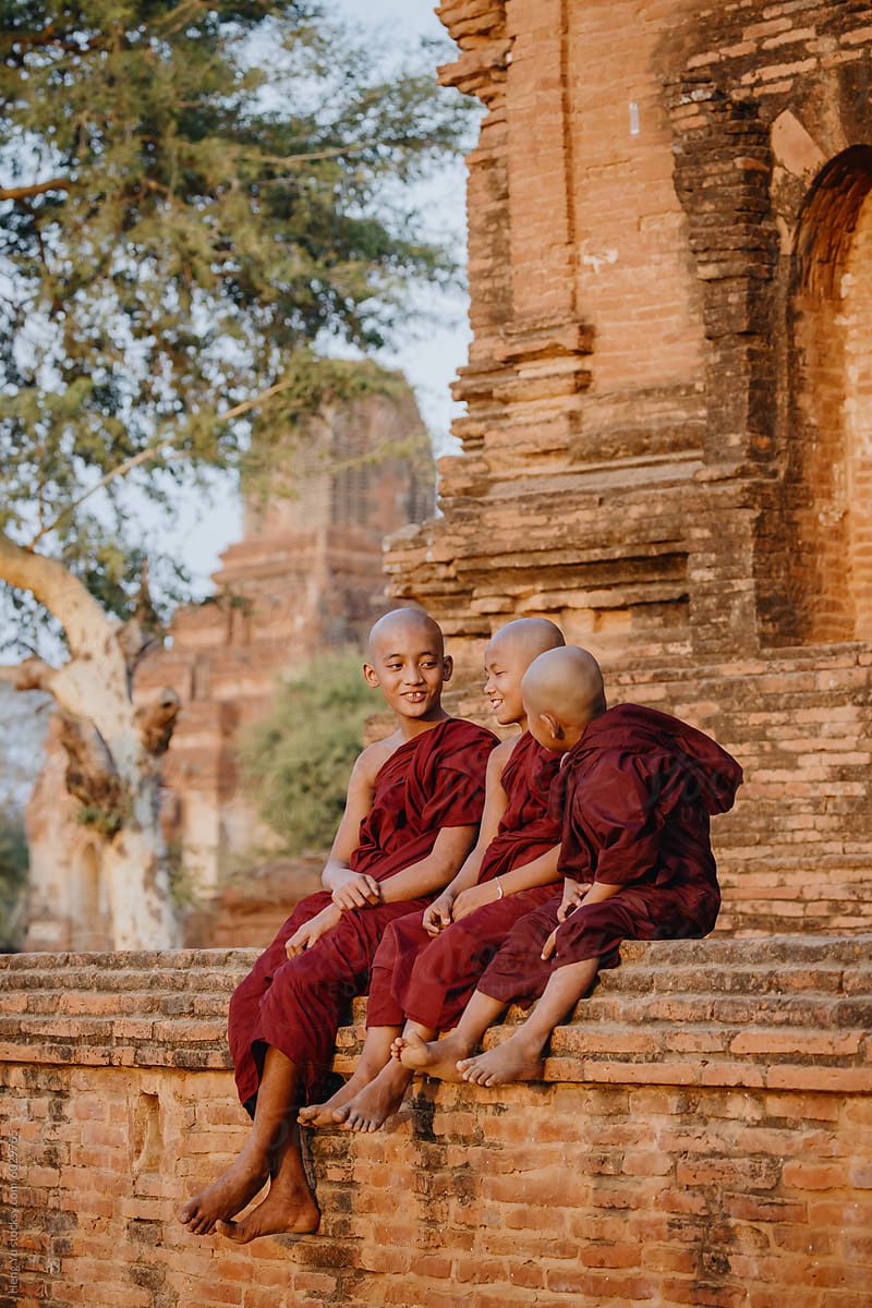 Young monks sharing a moment on temple ruins