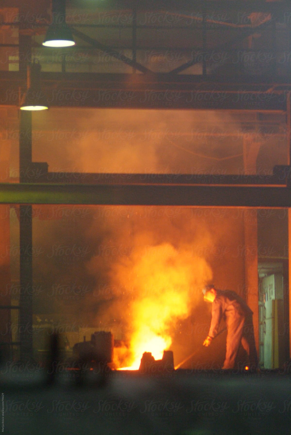 worker in a melting metal old factory