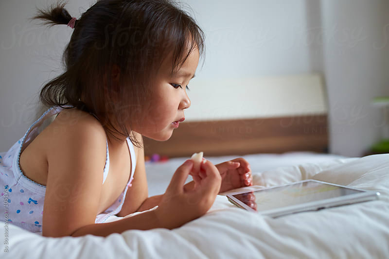 Little girl using tablet indoor