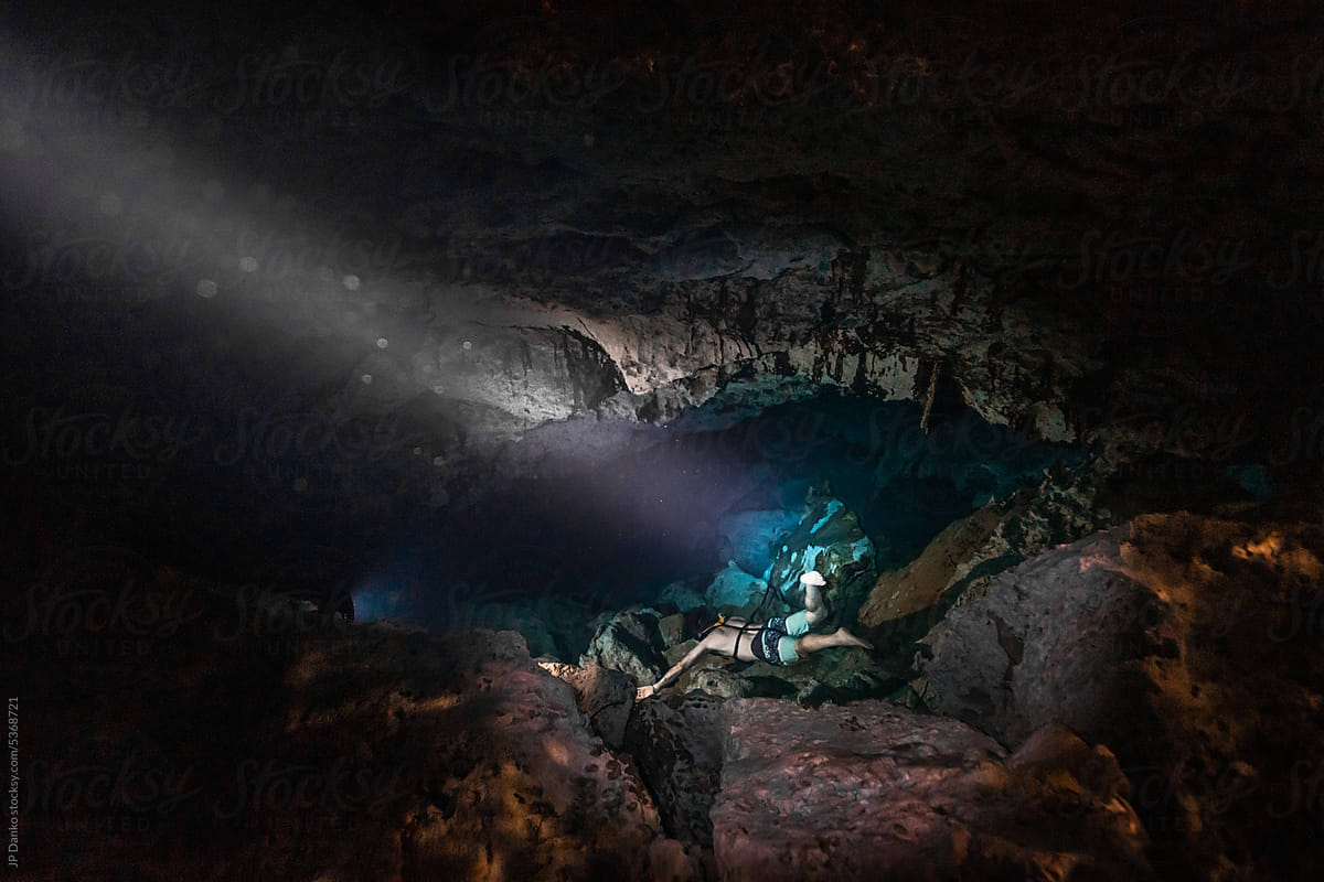 Man Diving Underwater in Cenote Cave in Tulum Mexico
