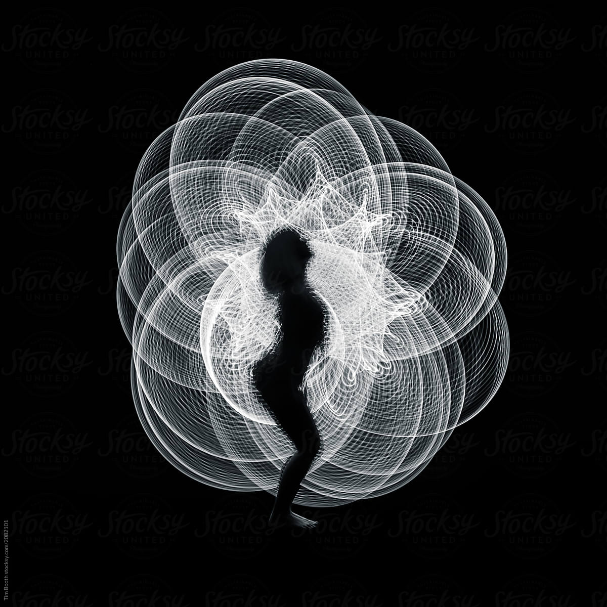 Silhouette of a girl in front of a spiral of light