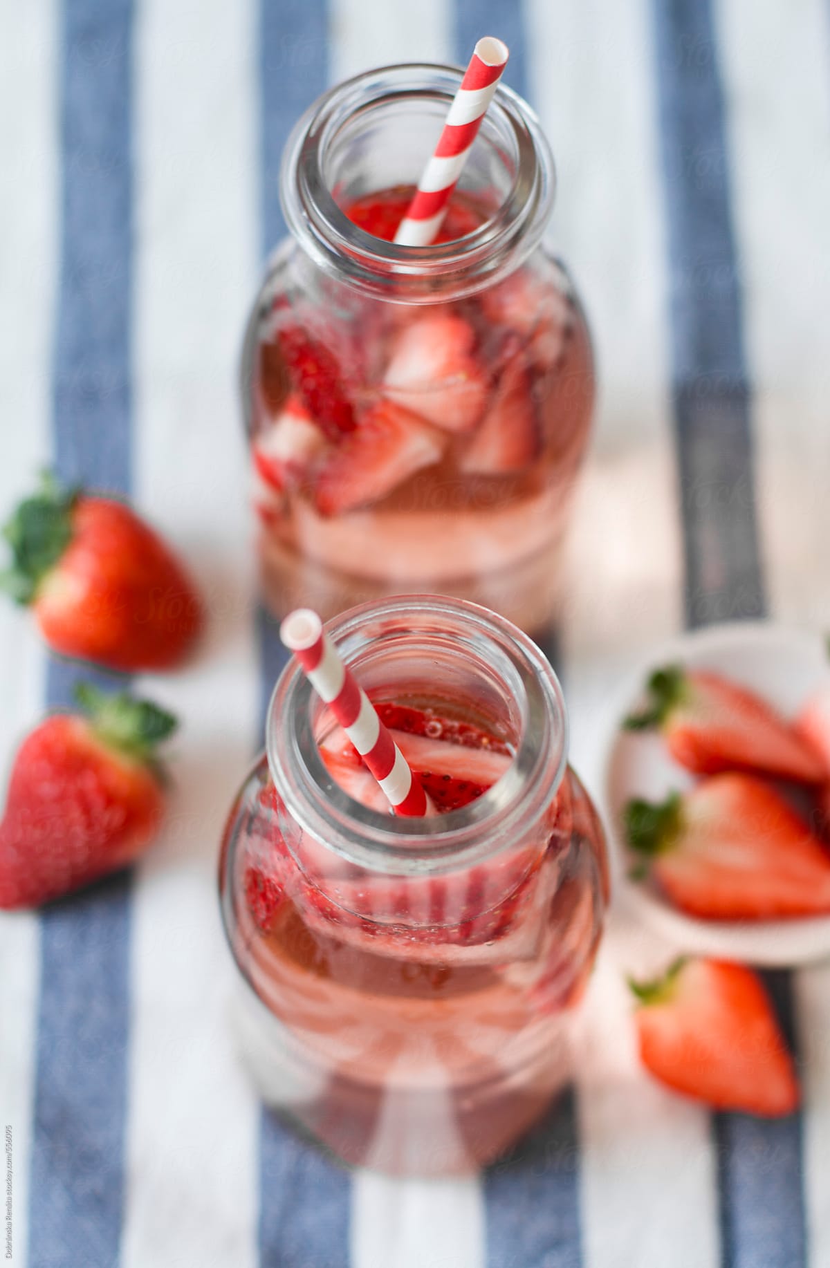Bottles of strawberry lemonade with straws