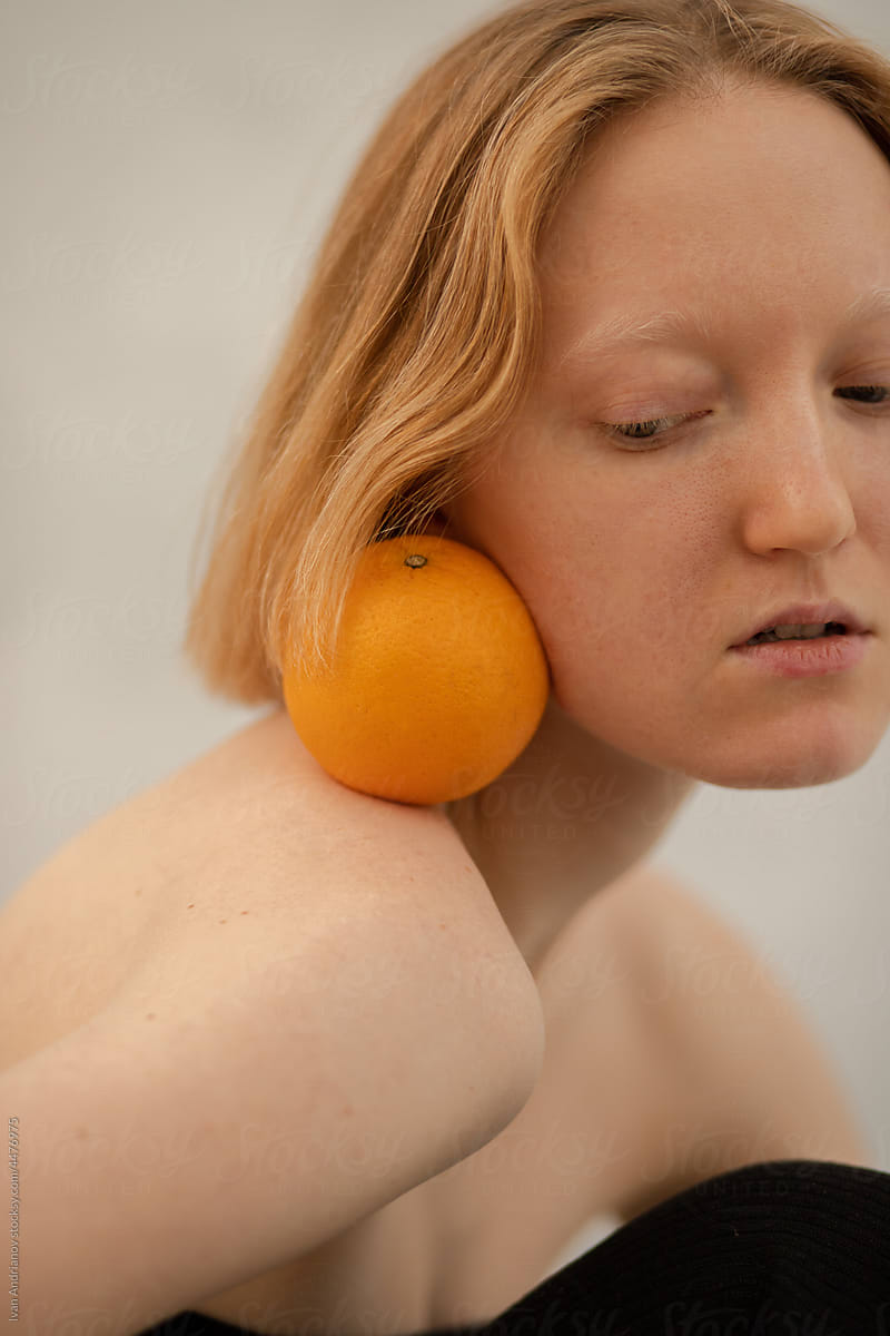 Young blonde woman with orange