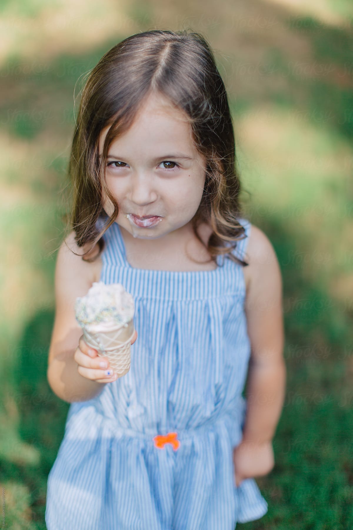 Cute And Happy Young Girl Eating Ice Cream Outside By Stocksy Contributor Jakob Lagerstedt