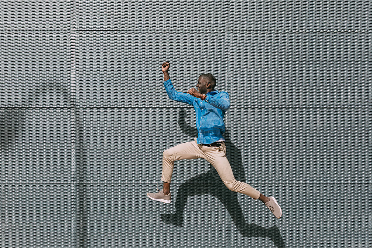 Black man jumping in the street