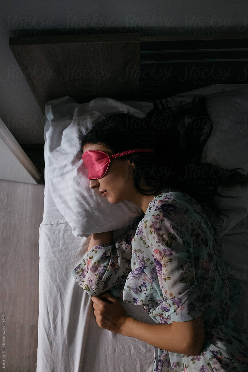 Woman Sleeping With a Pink Sleeping Mask