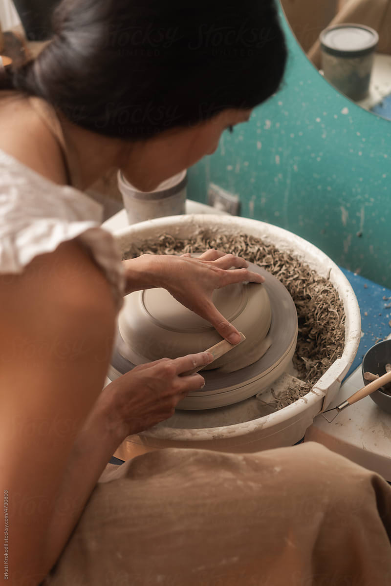 Close Up Of Potter Working On The Clay Bowl On The Wheel