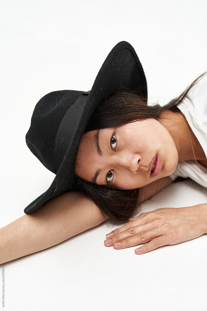 Asian woman in stylish hat looking at camera