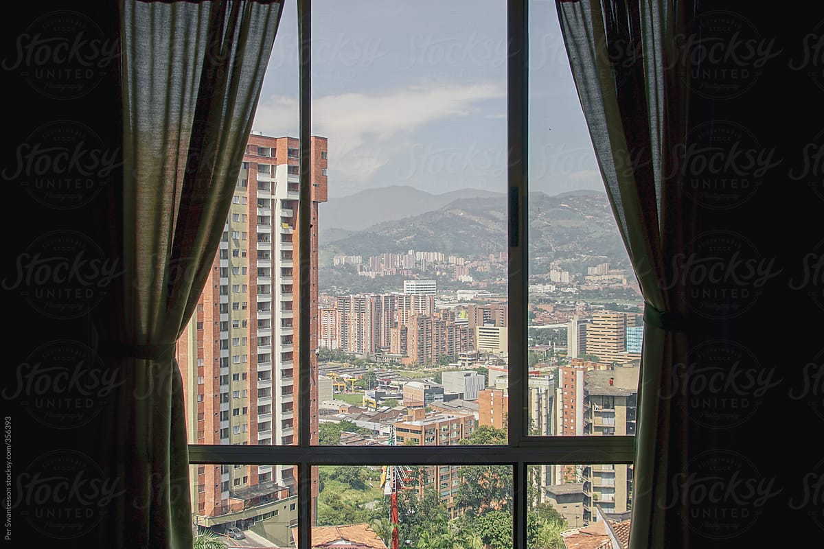 View through through curtains of high rise neighborhood in Medellin, Colombia