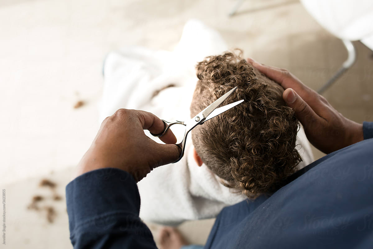 High angle view of man cutting son\'s hair