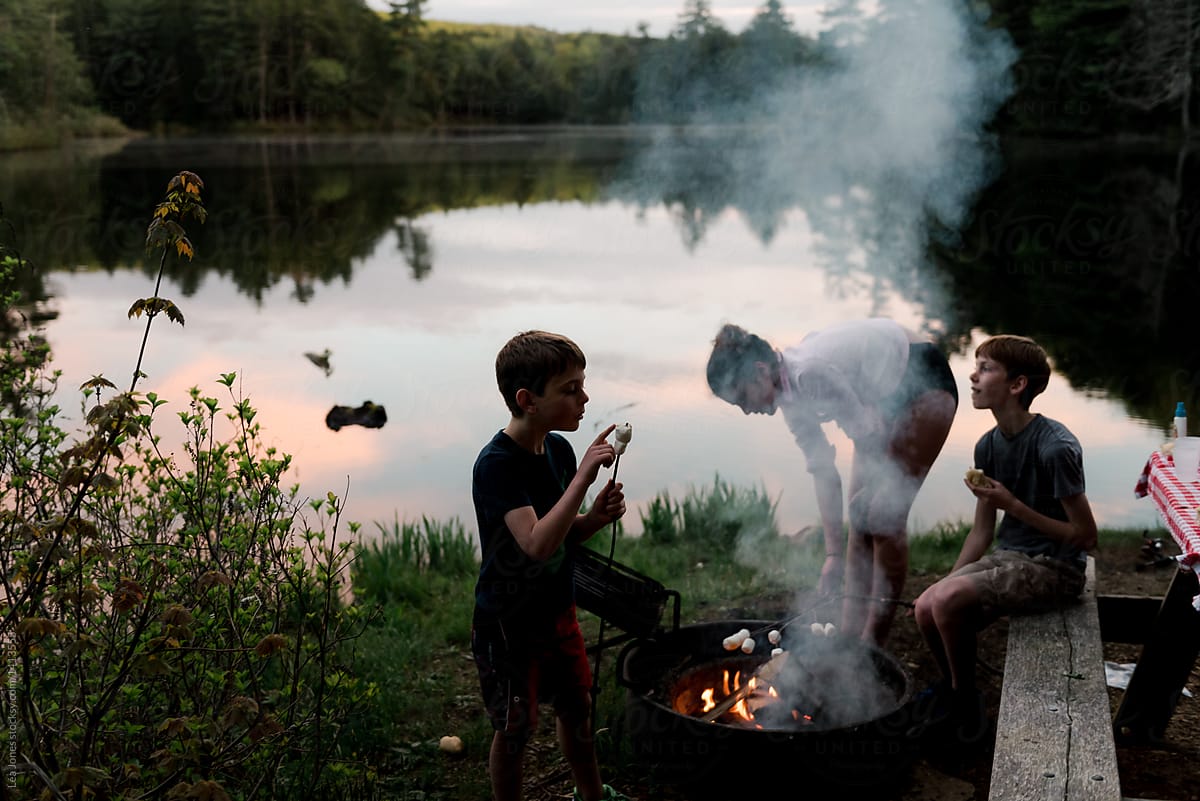 kids grilling marshmallows on campfire