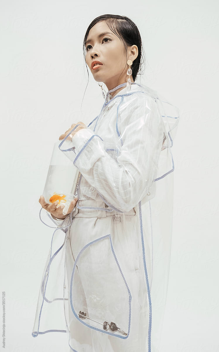 Female in white fashionable outfilt with goldfish.
