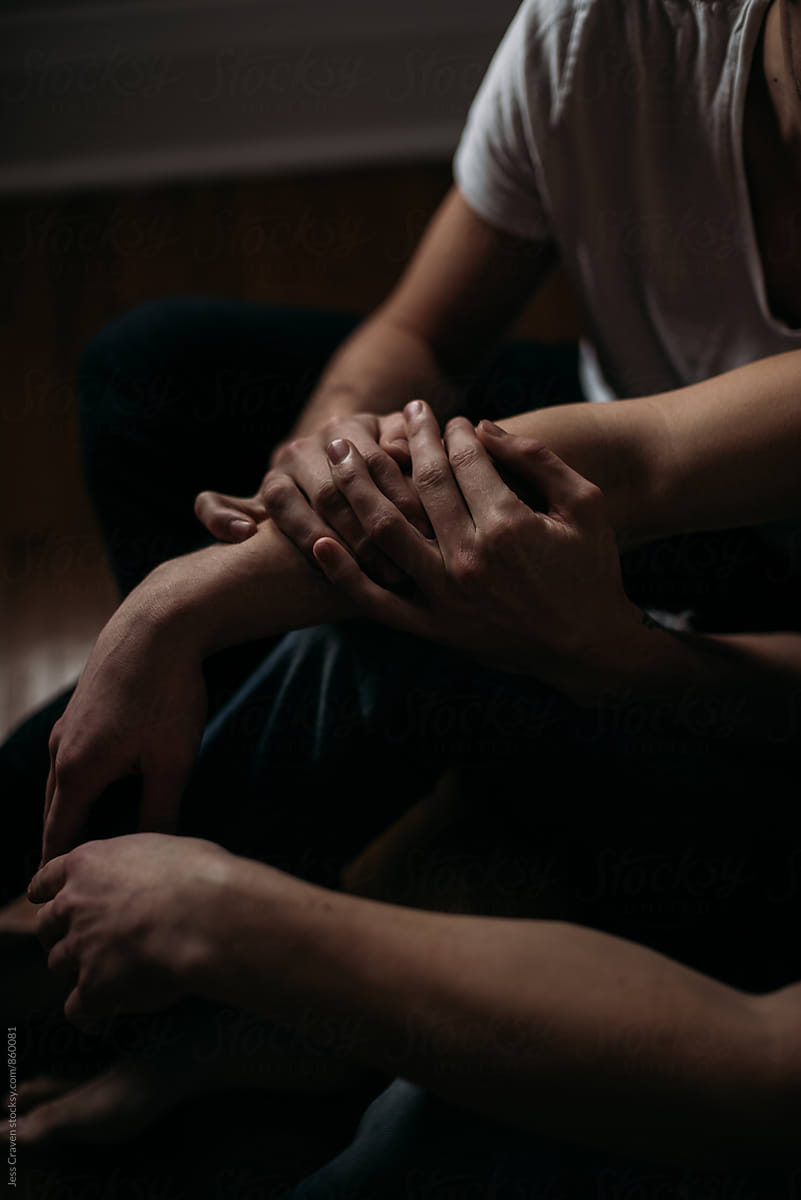 «young Gay Couple Sitting On Bedroom Floor Holding Hands Del