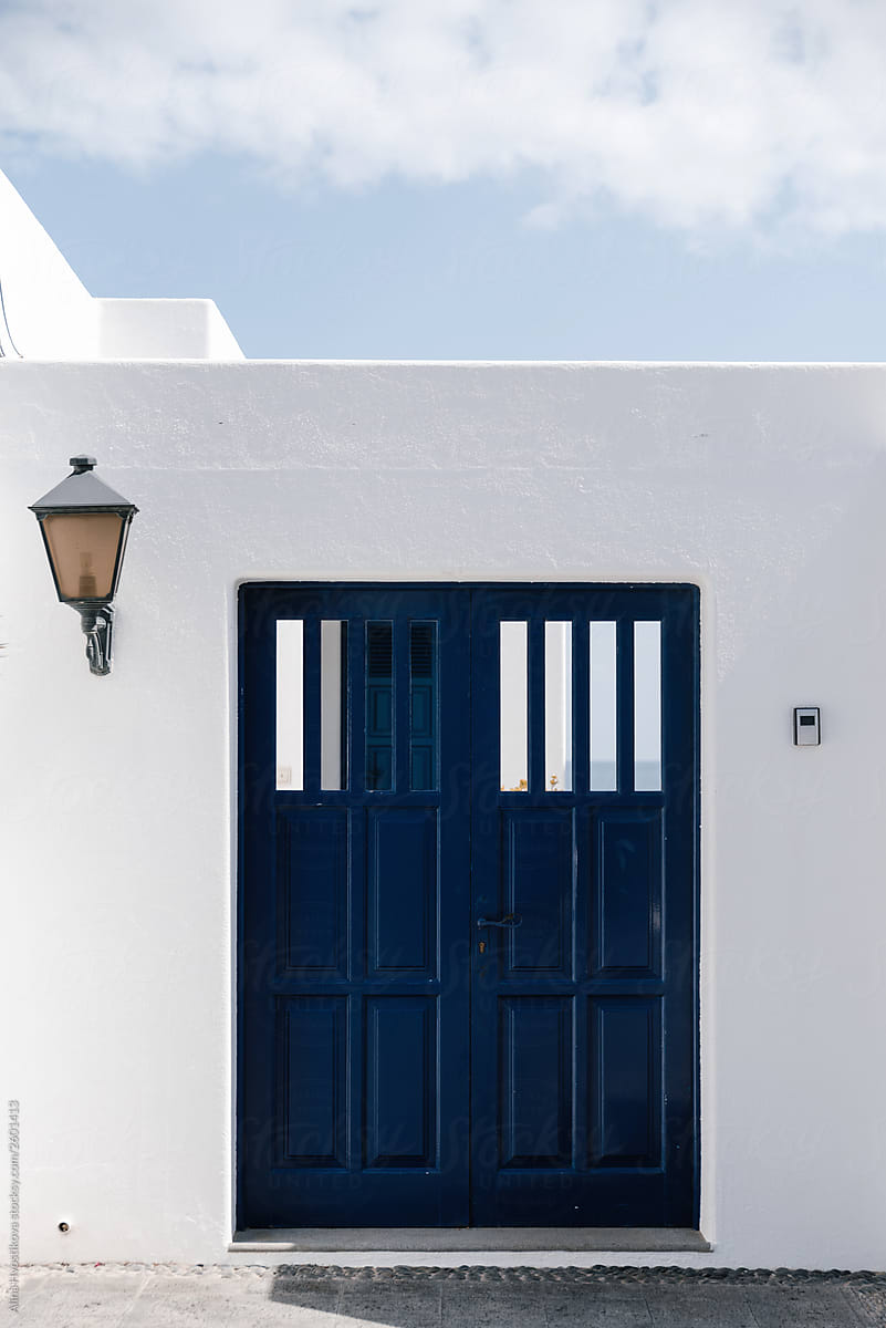 White wall with dark blue wooden door.