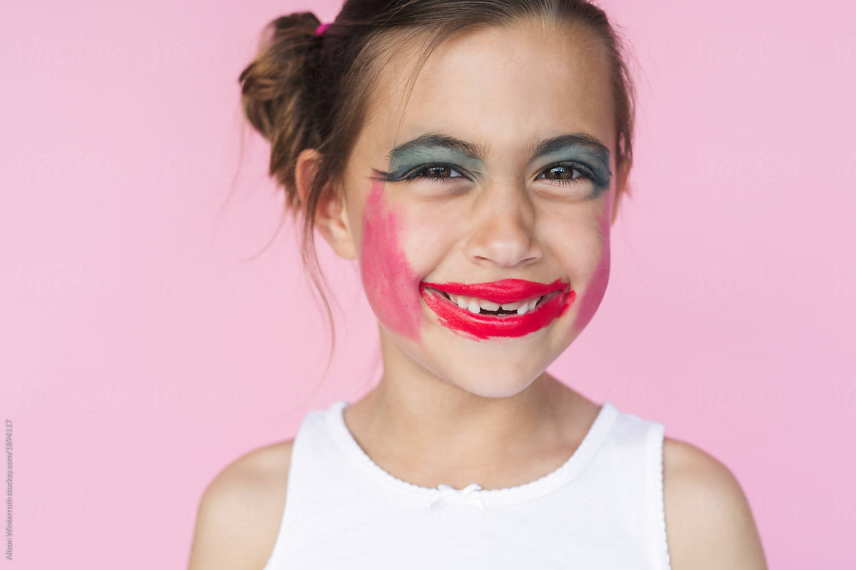 A Seven Year Old Girl Making A Funny Face With Makeup On By Stocksy 
