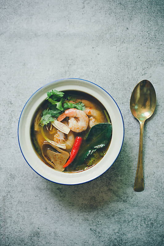 A bowl of Thai Tom Yam soup by Alita Ong - Stocksy United