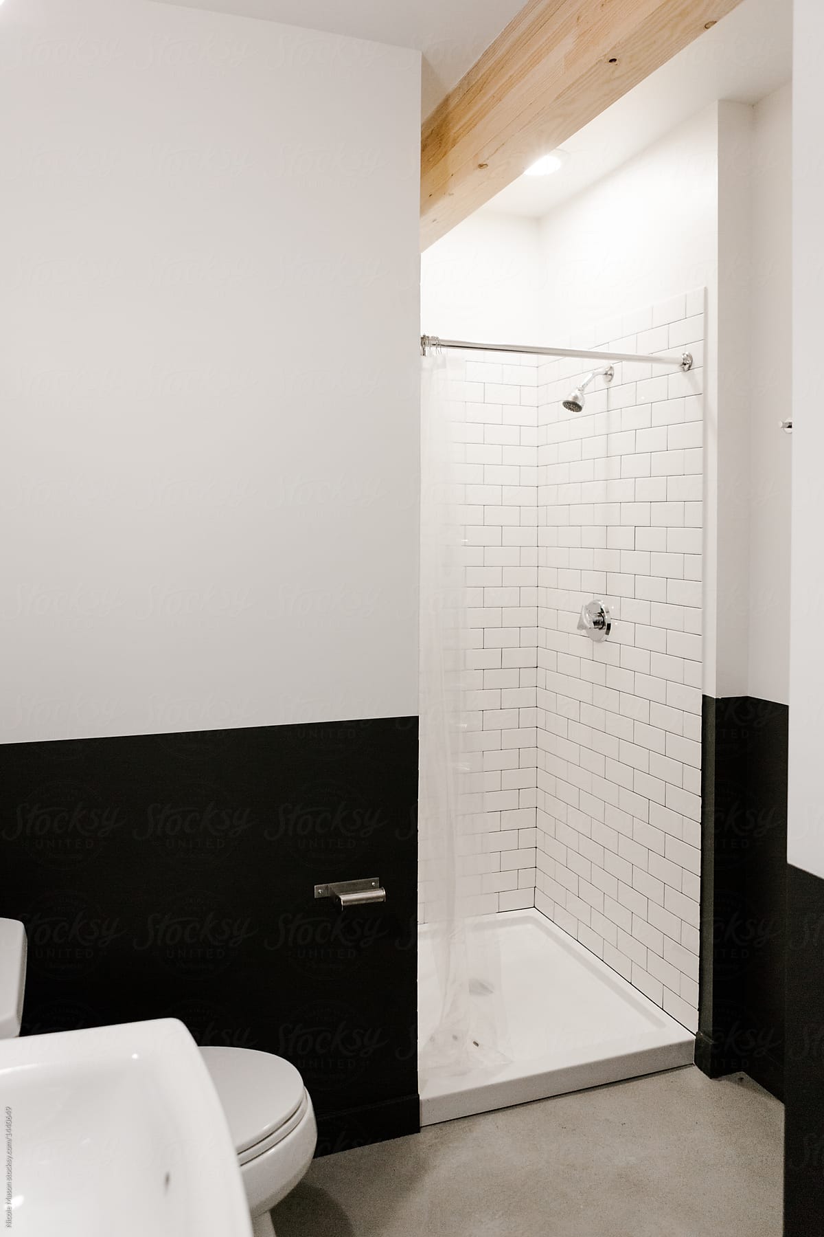 modern bathroom with walls painted half black and half white