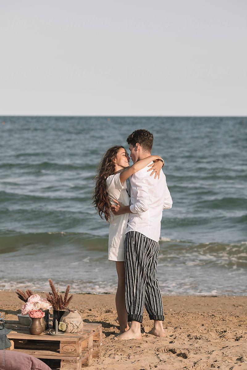 Young Couple In Love Walking On Te Shoreline
