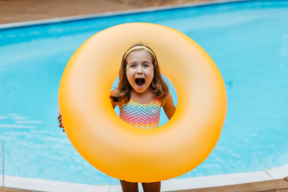 Cute girl showing her excitement over her inner tube