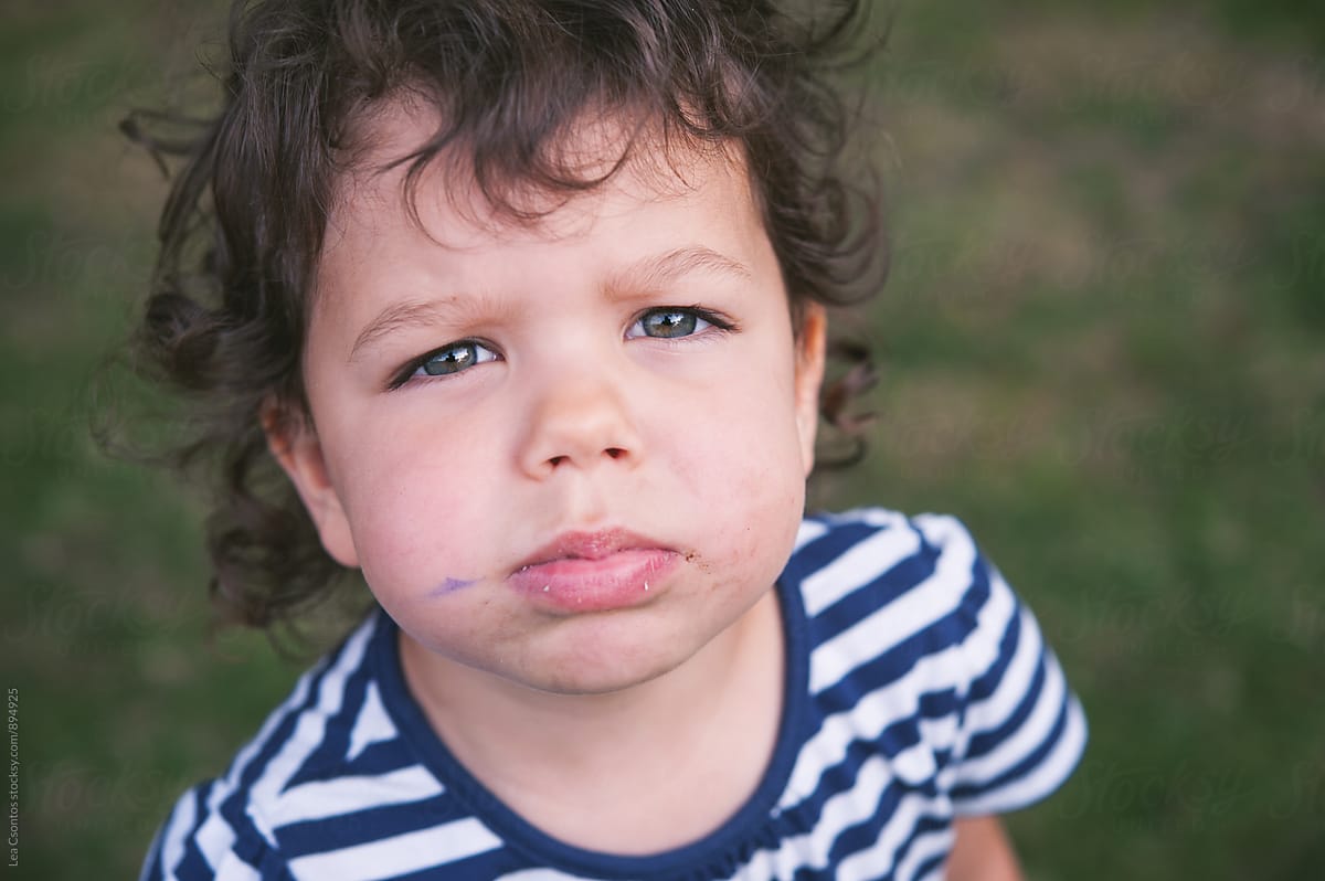 Portrait of a child with a messy, dirty face looking at camera