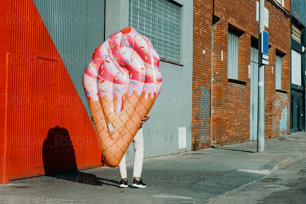 man carrying an ice cream cone floaty