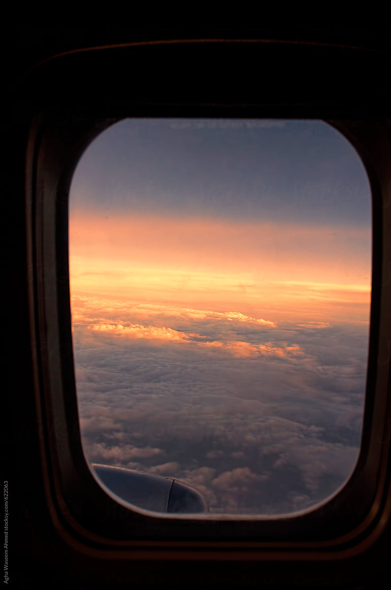 cloudy Sunset above the clouds from window of an airplane