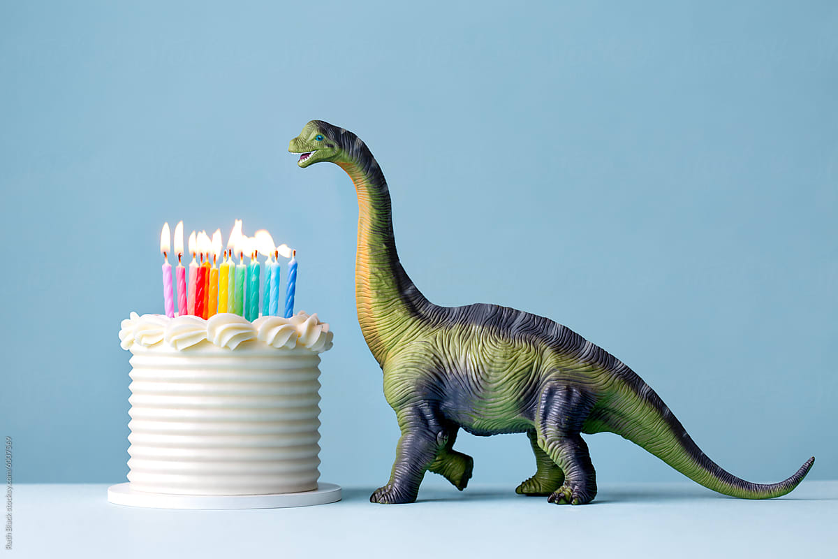 Dinosaur celebrating with a birthday cake