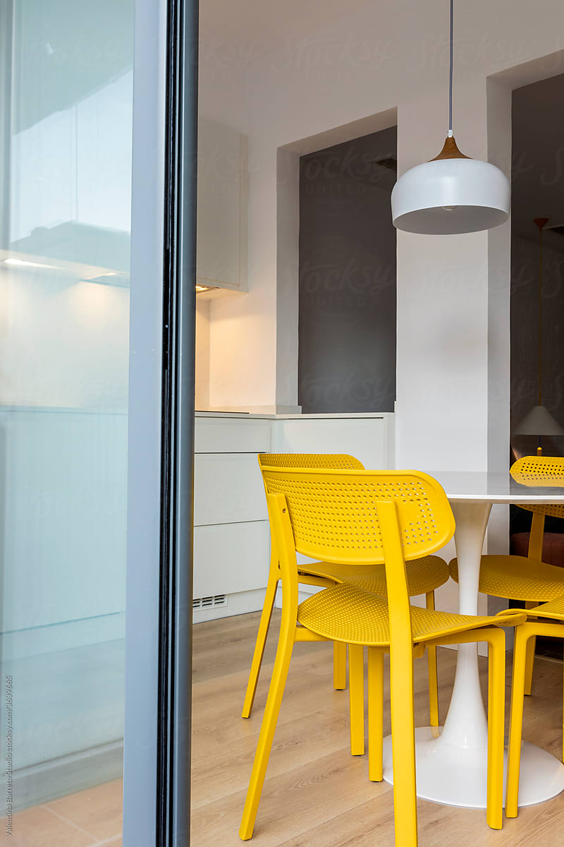 stylish Kitchen with yellow chairs by the window