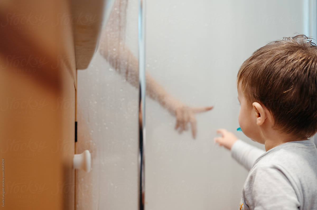 Child reaching out to mom in shower